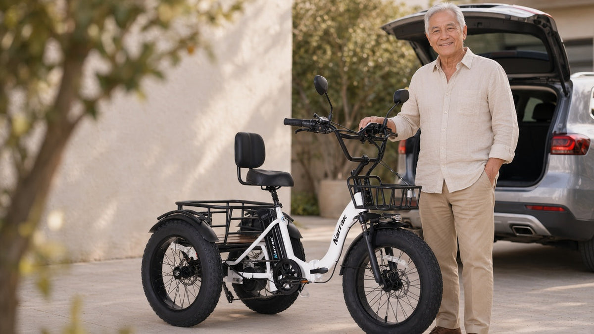 Folding electric trike for seniors — Narrak S180 white folding three-wheel e-trike by an SUV trunk